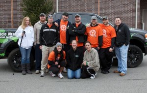 stick team standing outside in front of truck